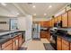 Modern kitchen with stainless steel appliances, plenty of cabinet space, and an open view to the living room area at 19585 W Washington St, Buckeye, AZ 85326