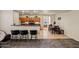 Open-concept layout showcasing the kitchen with breakfast bar, adjacent dining space, and seamless flow to the living room at 19585 W Washington St, Buckeye, AZ 85326