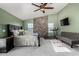 Bedroom with a ceiling fan, a treadmill, and a decorative wooden accent wall at 2149 E Hermosa Vista Dr, Mesa, AZ 85213