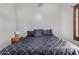 Comfortable bedroom features a queen bed with dark bedding and a wooden nightstand at 2149 E Hermosa Vista Dr, Mesa, AZ 85213