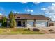 Charming home featuring stone accents, a three-car garage, and a well-maintained front yard at 2149 E Hermosa Vista Dr, Mesa, AZ 85213