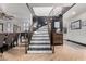 Stylish foyer with curved staircase, modern decor, and plenty of natural light at 2149 E Hermosa Vista Dr, Mesa, AZ 85213