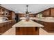 Spacious kitchen featuring a large island, custom wood cabinetry, and stainless steel appliances at 2149 E Hermosa Vista Dr, Mesa, AZ 85213