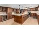 Gourmet kitchen features custom cabinetry, granite countertops, and large center island at 2149 E Hermosa Vista Dr, Mesa, AZ 85213