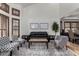 Open living room with tall ceilings, shuttered windows, and designer furniture at 2149 E Hermosa Vista Dr, Mesa, AZ 85213