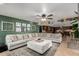 Open living room with a view of kitchen, modern ceiling fan and large sectional sofa at 2149 E Hermosa Vista Dr, Mesa, AZ 85213