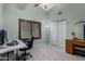 Home office with ceiling fan, light blue walls, window with shutters, and built-in storage at 2149 E Hermosa Vista Dr, Mesa, AZ 85213
