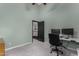 Home office with desk, rolling chair, closet, and blue walls at 2149 E Hermosa Vista Dr, Mesa, AZ 85213