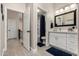 Bathroom with white cabinets, marble countertops, and modern lighting next to the toilet and shower at 220 N 22Nd Pl # 1022, Mesa, AZ 85213