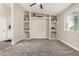 Cozy bedroom with built-in shelves, soft carpet, a ceiling fan, and a well-lit window, creating a welcoming space at 220 N 22Nd Pl # 1022, Mesa, AZ 85213