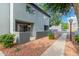 Apartment exterior with private patios, rock landscaping, and sidewalk at 220 N 22Nd Pl # 1022, Mesa, AZ 85213