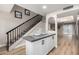 Modern kitchen featuring stainless steel appliances, gray countertops, and a breakfast bar leading to a staircase and living room at 220 N 22Nd Pl # 1022, Mesa, AZ 85213