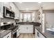 Well-equipped kitchen with stainless steel appliances, gray countertops, a window, and stylish decor at 220 N 22Nd Pl # 1022, Mesa, AZ 85213