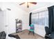 A bedroom featuring a futon, desk, shelf, and a blue chair near a window with natural light at 2301 E University Dr # 341, Mesa, AZ 85213