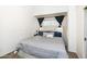 A cozy bedroom featuring a queen bed with a stylish headboard and grey striped bedding at 2301 E University Dr # 341, Mesa, AZ 85213