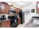 Functional kitchen with modern appliances, black refrigerator, and granite countertops, ideal for cooking at 2301 E University Dr # 341, Mesa, AZ 85213