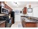 Well-lit kitchen with updated appliances, granite countertops, and tiled floor, maximizing space at 2301 E University Dr # 341, Mesa, AZ 85213