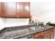 Granite countertop in kitchen, seamlessly connecting the kitchen to living area and a stainless sink at 2301 E University Dr # 341, Mesa, AZ 85213