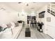 A cozy living room with a comfortable sofa, open to the kitchen and dining area, features modern grey vinyl flooring at 2301 E University Dr # 341, Mesa, AZ 85213
