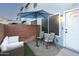 Cozy patio with stylish seating under a blue umbrella, perfect for relaxing outdoors at 2301 E University Dr # 341, Mesa, AZ 85213
