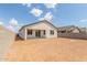 View of the backyard and exterior of the home with a block fence at 25332 N 133Rd Ave, Peoria, AZ 85383