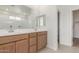 Bathroom featuring double sink vanity, large mirror, and bright lighting at 25332 N 133Rd Ave, Peoria, AZ 85383