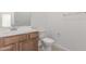 This bathroom includes a toilet, sink, vanity, mirror and towel rack at 25332 N 133Rd Ave, Peoria, AZ 85383