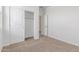 This bedroom features neutral carpet, a closet, and a door to the rest of the house at 25332 N 133Rd Ave, Peoria, AZ 85383