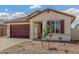 Charming single-story home featuring a two-car garage and a beautifully landscaped front yard with desert accents at 25332 N 133Rd Ave, Peoria, AZ 85383