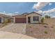 Inviting single-story home featuring a two-car garage and desert-friendly landscaping at 25332 N 133Rd Ave, Peoria, AZ 85383