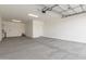 This is an empty two car garage with painted walls and a cement floor at 25332 N 133Rd Ave, Peoria, AZ 85383