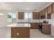Modern kitchen featuring stainless steel appliances, wooden cabinets, and bright natural light at 25332 N 133Rd Ave, Peoria, AZ 85383