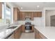 Bright kitchen featuring stainless steel appliances, wooden cabinets, and a large window at 25332 N 133Rd Ave, Peoria, AZ 85383