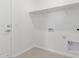 This laundry room has a shelf, tiled floors, and hookups for a washer and dryer at 25332 N 133Rd Ave, Peoria, AZ 85383