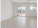 Bright living room with sliding glass doors leading to the backyard and tile flooring at 25332 N 133Rd Ave, Peoria, AZ 85383
