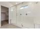 Modern glass enclosed shower with bench, sleek fixtures, and neutral tile at 25332 N 133Rd Ave, Peoria, AZ 85383
