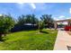Lush backyard featuring a well-maintained lawn, a pergola, and a built-in grill, perfect for outdoor entertaining at 2635 W Atlanta Ave, Phoenix, AZ 85041