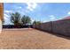 Spacious backyard with gravel, a seating area, and tall block wall at 2635 W Atlanta Ave, Phoenix, AZ 85041