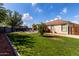 Green backyard with block fence, covered patio and a dining pergola at 2635 W Atlanta Ave, Phoenix, AZ 85041