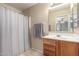 The bathroom features a shower and a vanity with a wood cabinet at 2635 W Atlanta Ave, Phoenix, AZ 85041