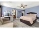 Spacious bedroom features wood-look floors, vanity, ceiling fan, and comfortable furnishings at 2635 W Atlanta Ave, Phoenix, AZ 85041