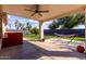 Relaxing covered patio with ceiling fan overlooks green lawn and backyard at 2635 W Atlanta Ave, Phoenix, AZ 85041