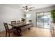 The dining room features tile floors, a ceiling fan, a large wood table and chairs, and sliding glass doors at 2635 W Atlanta Ave, Phoenix, AZ 85041