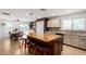Open concept kitchen with a large island, seating, and easy access to the wet bar and dining room at 2635 W Atlanta Ave, Phoenix, AZ 85041