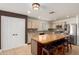 Open concept kitchen with a large island, seating, stainless steel appliances, and easy access to dining room at 2635 W Atlanta Ave, Phoenix, AZ 85041