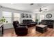 Bright living room with hardwood floors, large windows, ceiling fan and comfortable, modern furnishings at 2635 W Atlanta Ave, Phoenix, AZ 85041