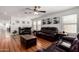 Bright living room with hardwood floors, large windows, ceiling fan and comfortable, modern furnishings at 2635 W Atlanta Ave, Phoenix, AZ 85041