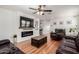 Bright living room with hardwood floors, a modern electric fireplace and comfortable, modern furnishings at 2635 W Atlanta Ave, Phoenix, AZ 85041