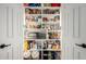 This walk-in pantry with double doors features ample shelving and storage space for food and kitchen essentials at 2635 W Atlanta Ave, Phoenix, AZ 85041
