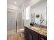 Bathroom featuring a glass shower, granite counters and dark wood cabinetry at 26355 N 79Th Dr, Peoria, AZ 85383